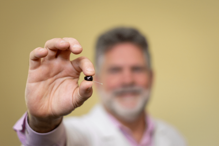 man holding a hearing aid