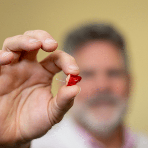 man holding hearing aid