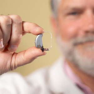 man holding hearing aid