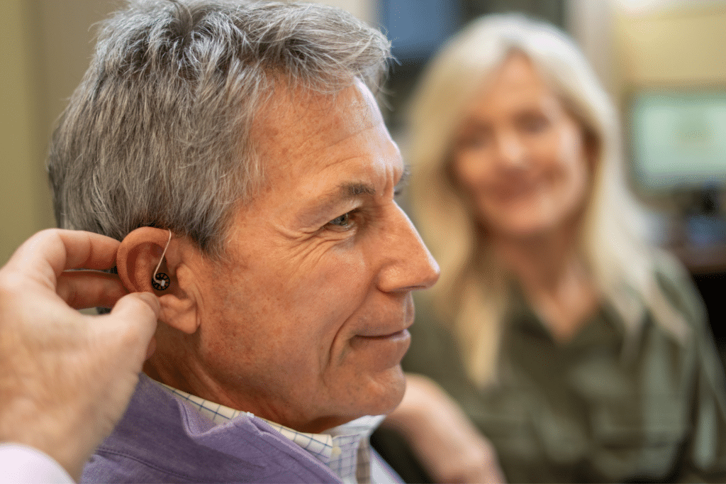 man receiving hearing aids