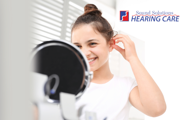 woman putting in hearing aid