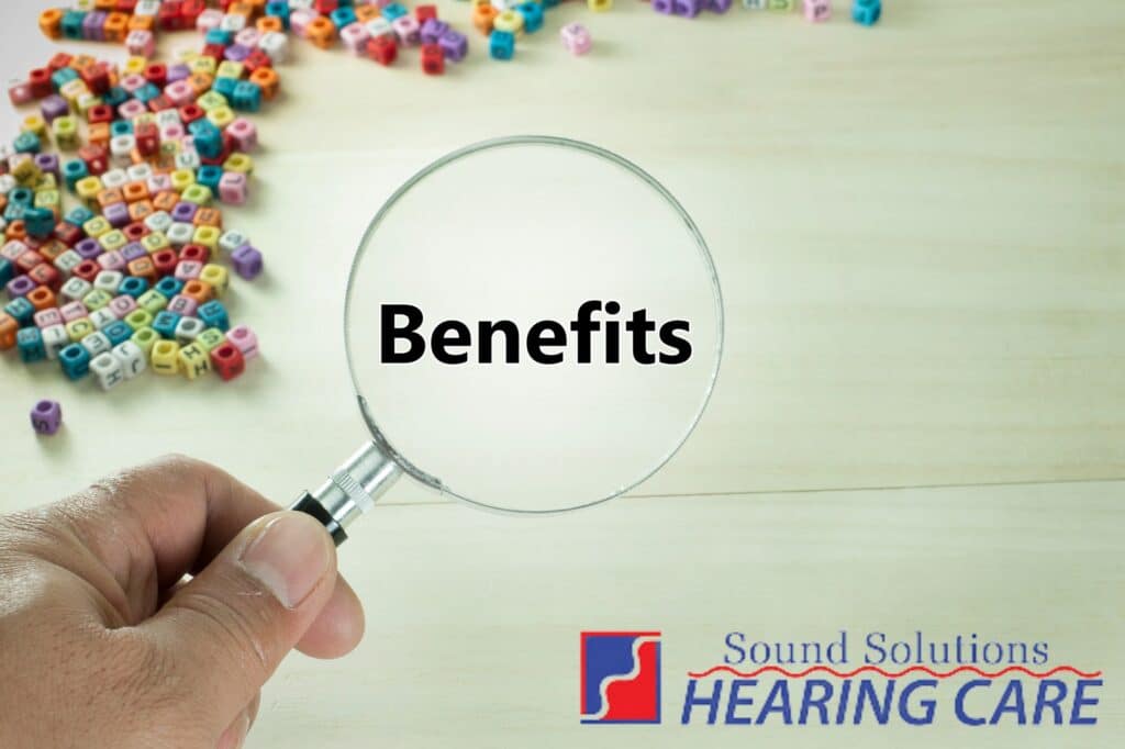 magnifying glass looking at the word benefits