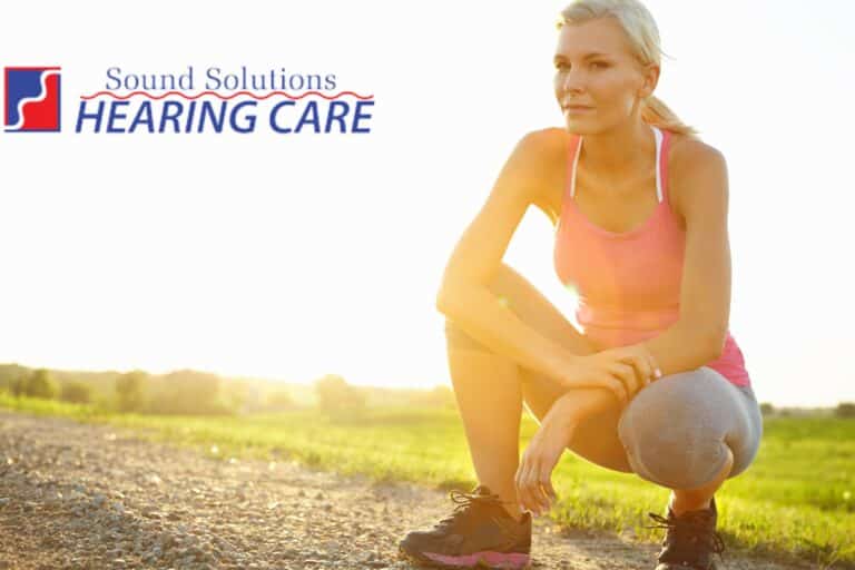 attractive older woman crouching in a field